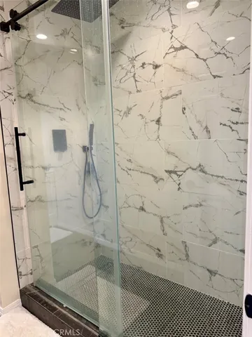 a bathroom with a tub sink and mirror