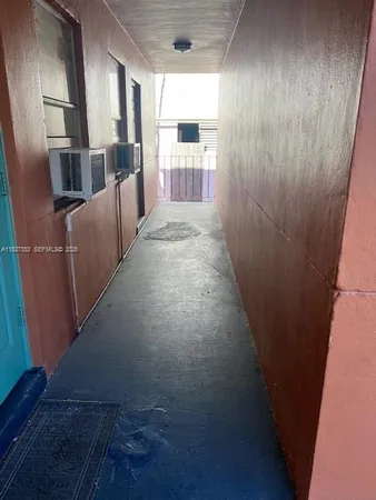 a view of a hallway with windows