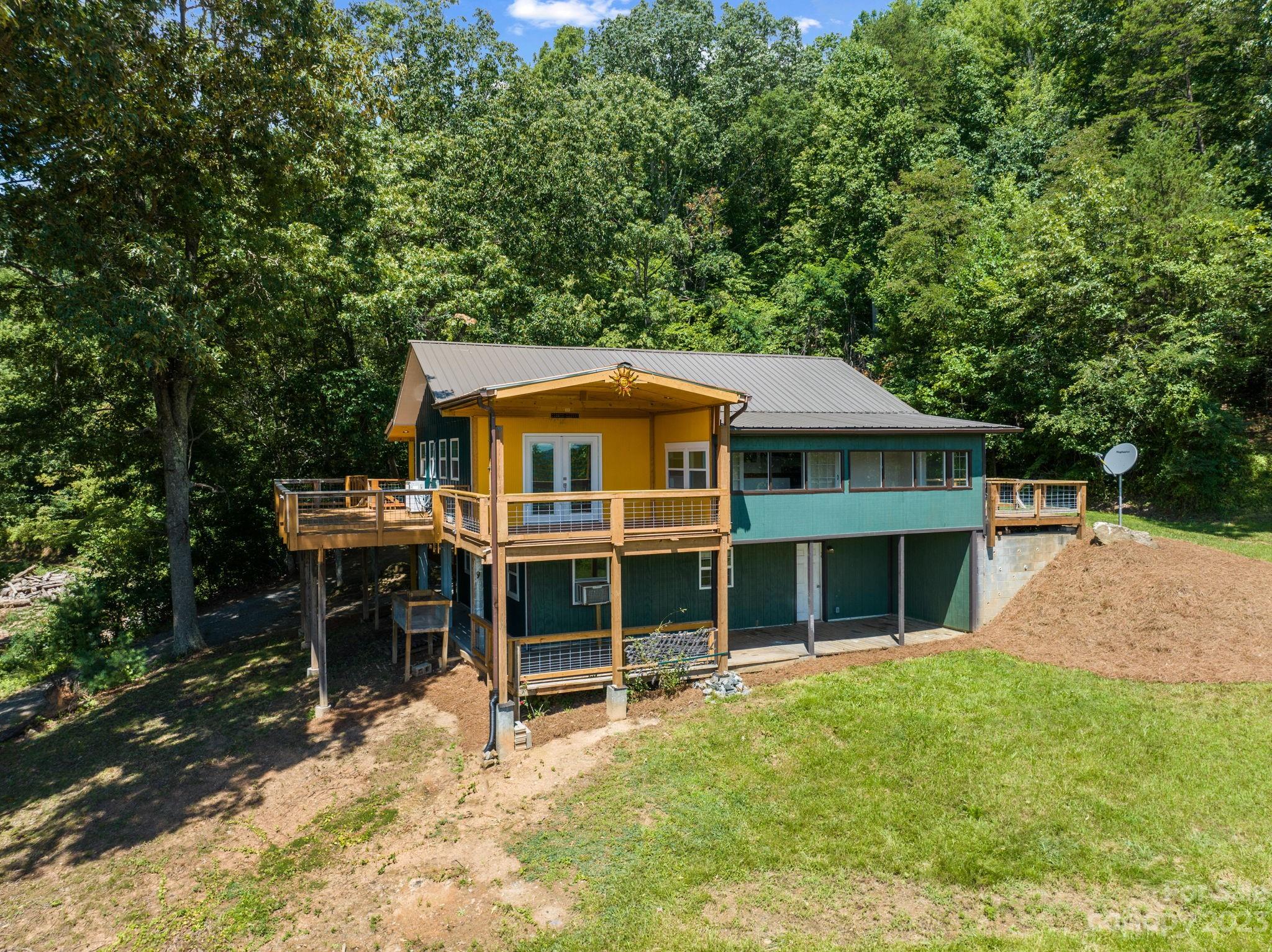 a view of a house with a backyard and sitting area