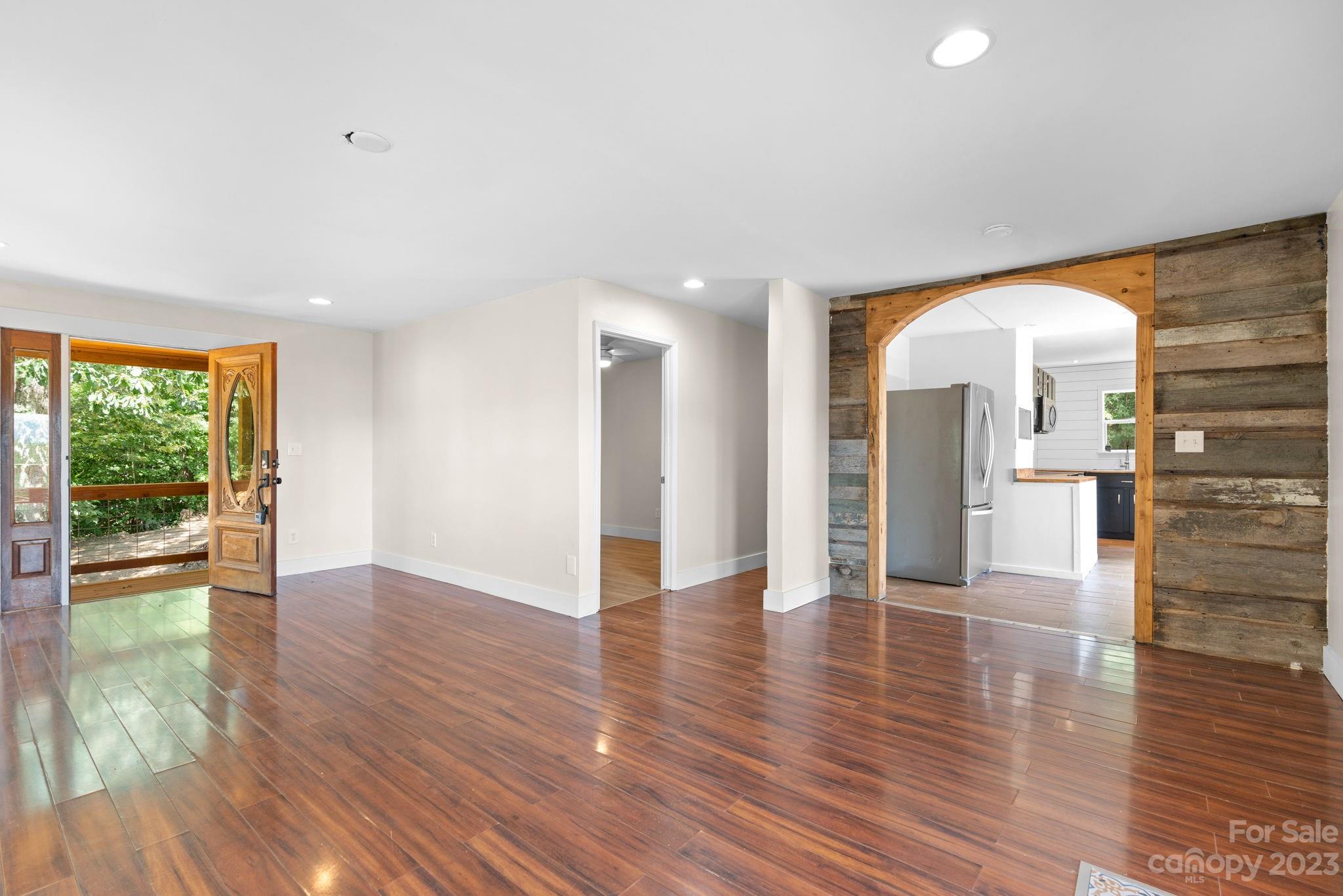 632 Thunder Road Clyde, NC 28721 - Photo 11 of 41 a view of an empty room with wooden floor and a window