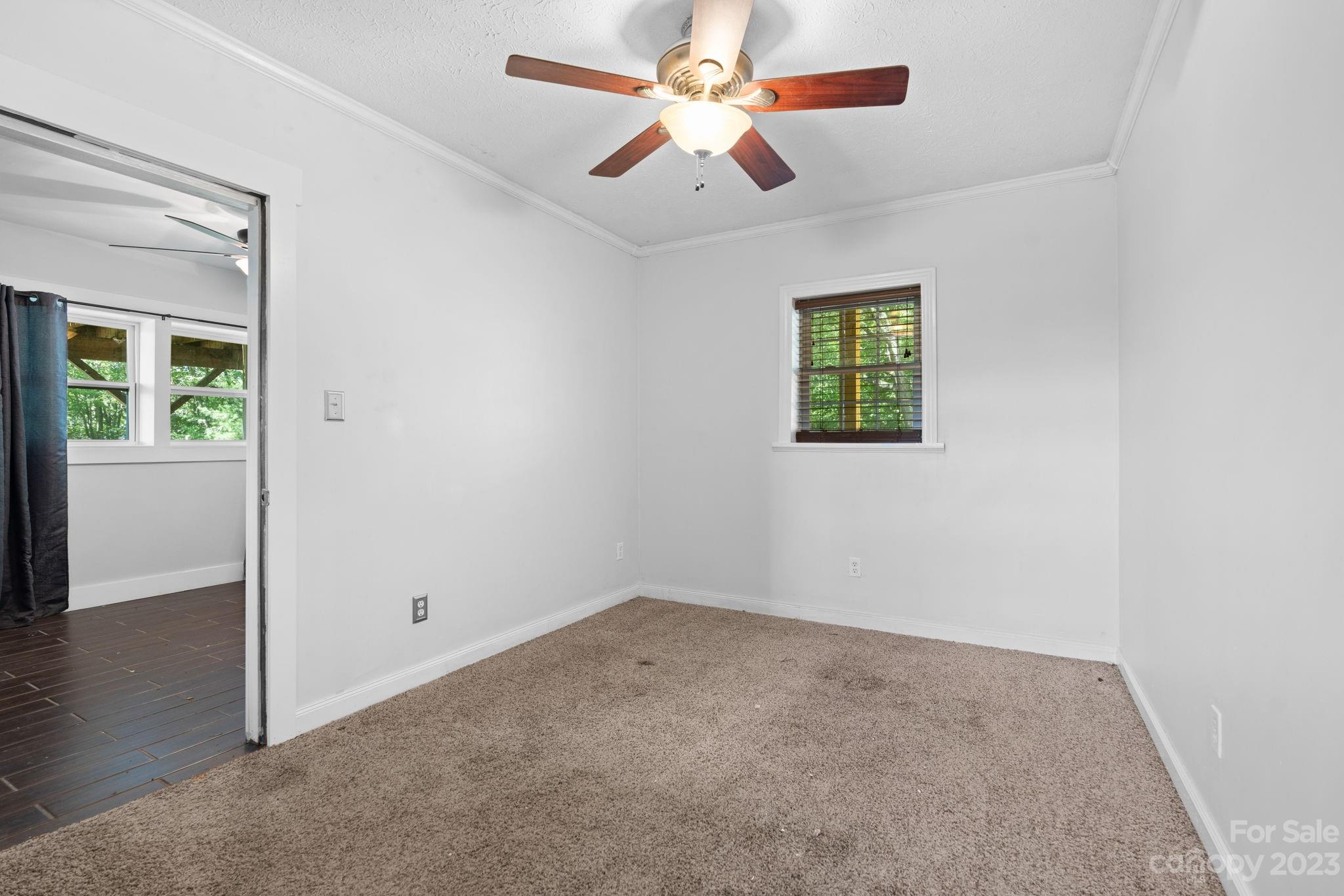 632 Thunder Road Clyde, NC 28721 - Photo 25 of 41 an empty room with windows and fan