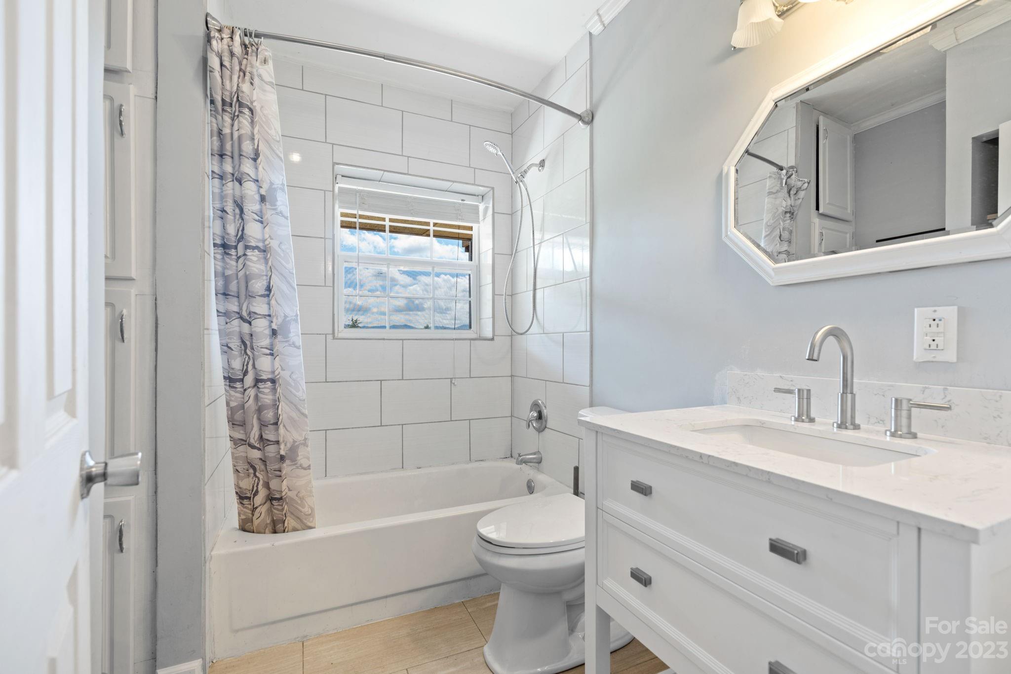 632 Thunder Road Clyde, NC 28721 - Photo 27 of 41 a bathroom with a sink a toilet and shower