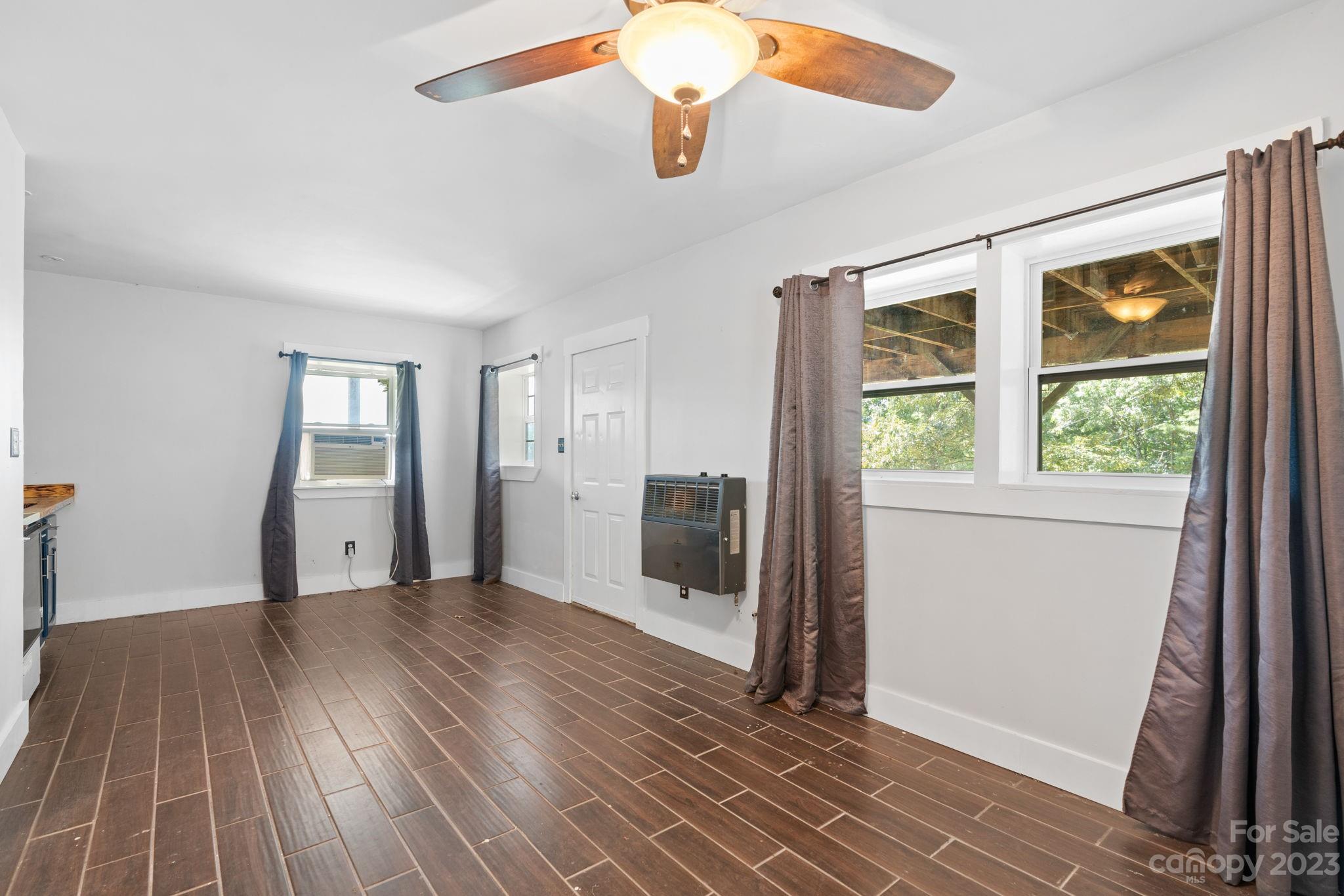 632 Thunder Road Clyde, NC 28721 - Photo 28 of 41 wooden floor in an empty room with a window