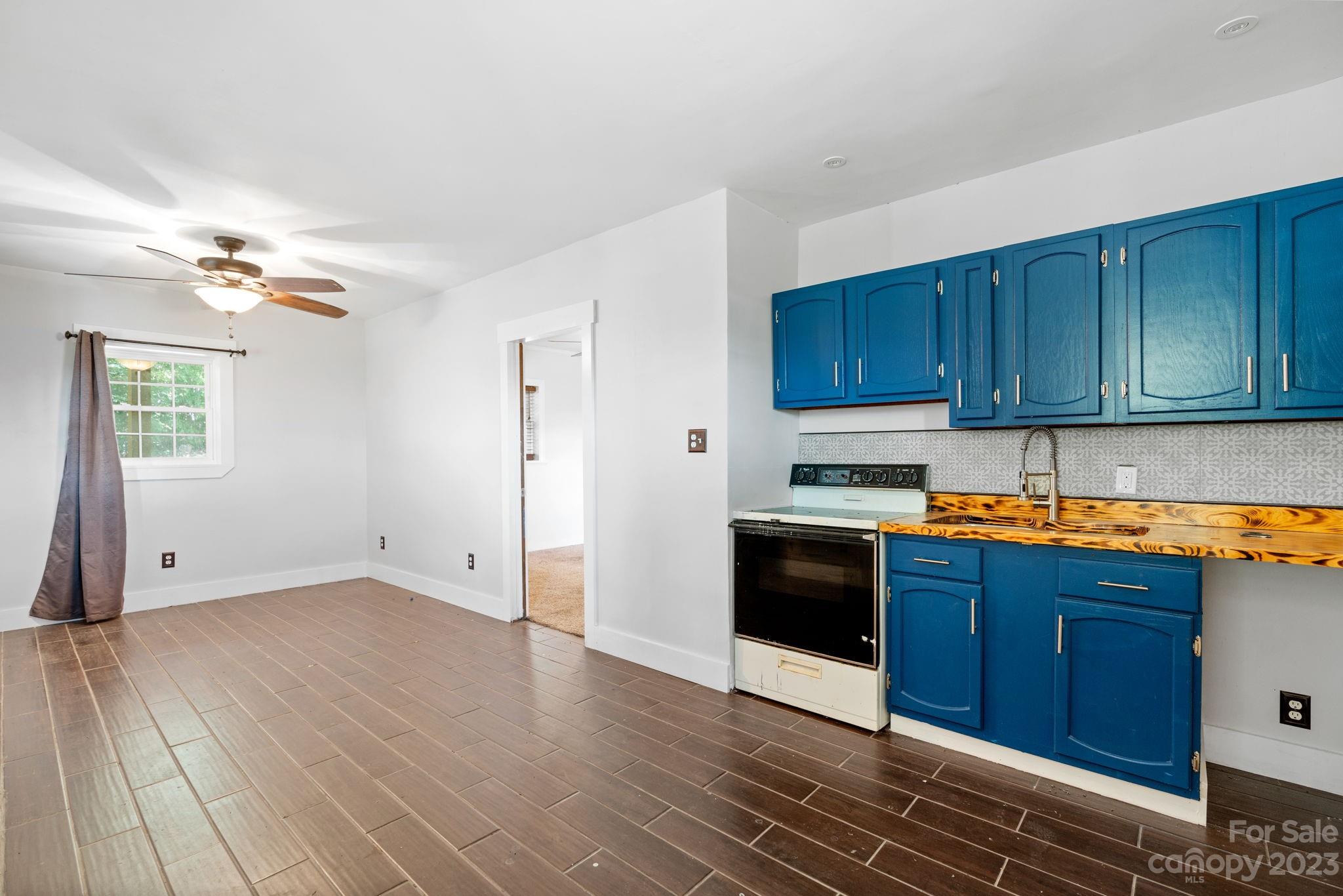 632 Thunder Road Clyde, NC 28721 - Photo 29 of 41 a kitchen with granite countertop wooden floors and stainless steel appliances