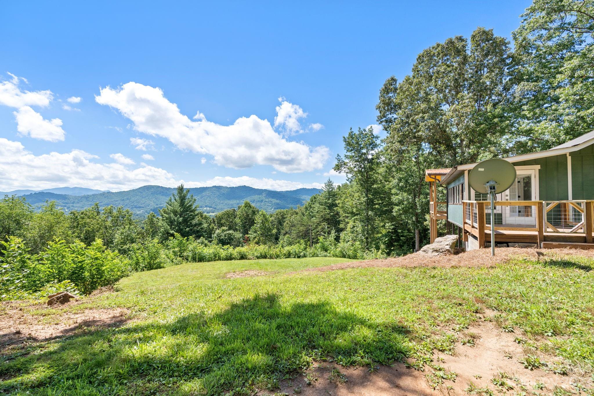 632 Thunder Road Clyde, NC 28721 - Photo 31 of 41 a view of a house with backyard and sitting area
