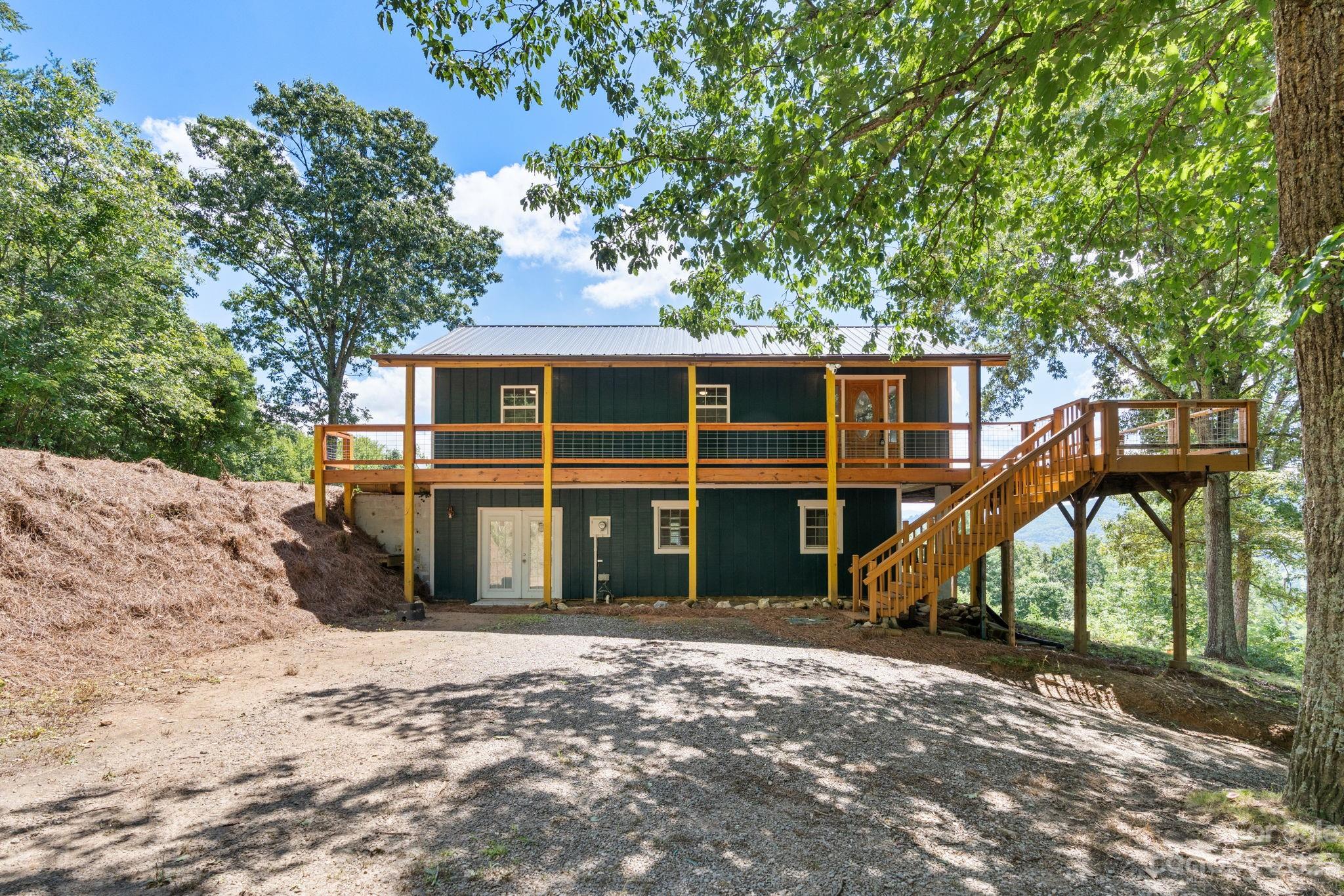632 Thunder Road Clyde, NC 28721 - Photo 7 of 41 a view of a house with a backyard