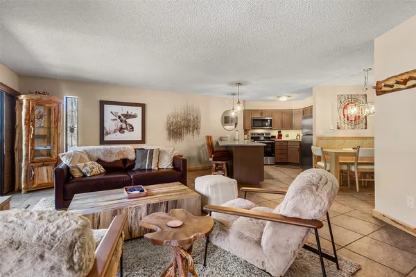 a living room with furniture and a kitchen view