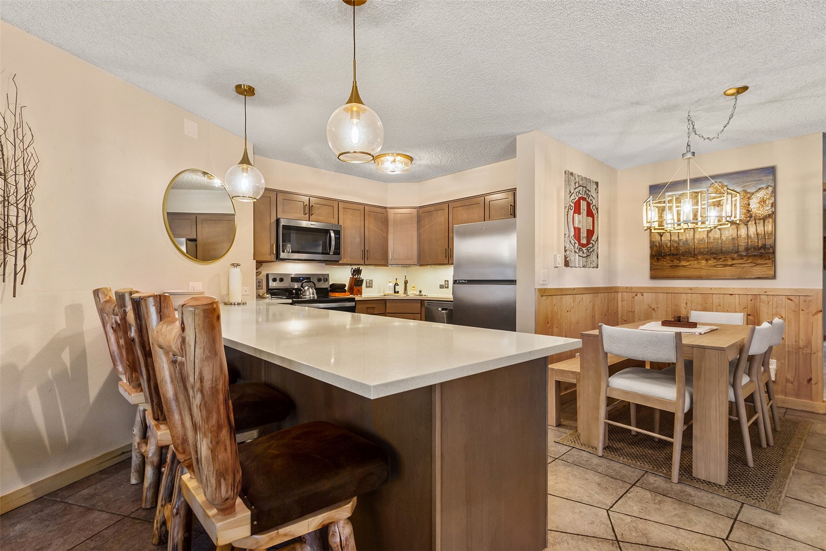 405 4 O Clock Road, Unit 15A Breckenridge, CO 80424 - Photo 13 of 50 a room with stainless steel appliances kitchen island a table and chairs