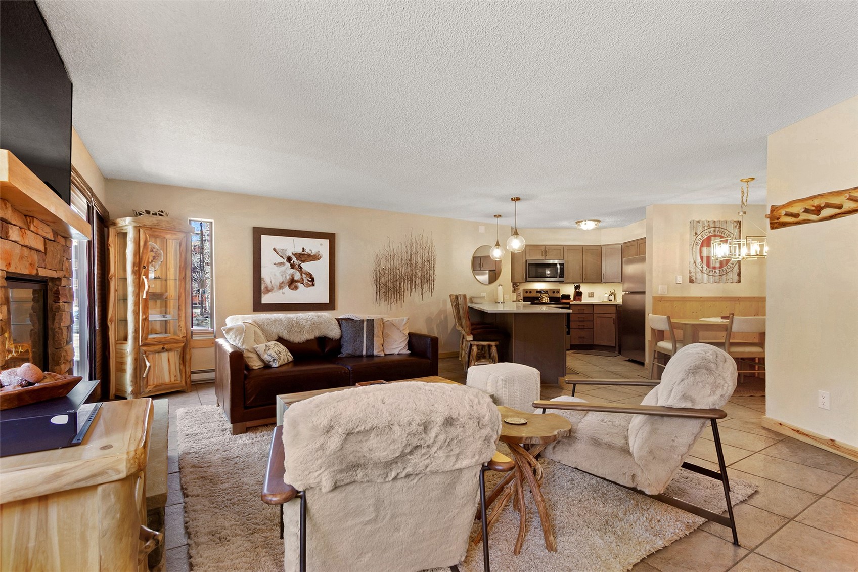 405 4 O Clock Road, Unit 15A Breckenridge, CO 80424 - Photo 15 of 50 a living room with furniture and a flat screen tv