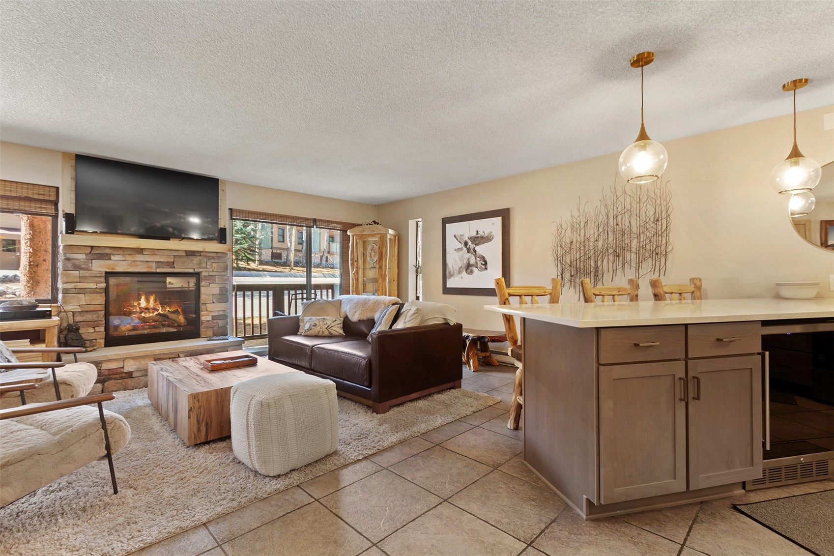 405 4 O Clock Road, Unit 15A Breckenridge, CO 80424 - Photo 19 of 50 a living room with furniture a fireplace and a flat screen tv