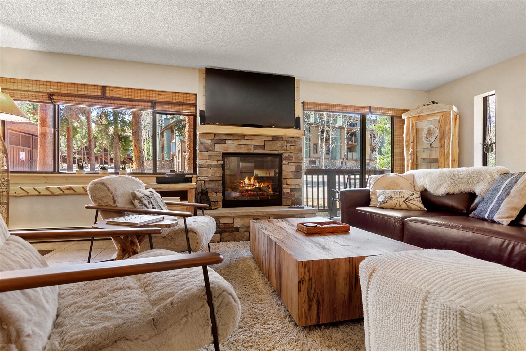 405 4 O Clock Road, Unit 15A Breckenridge, CO 80424 - Photo 20 of 50 a living room with furniture a flat screen tv and a fireplace