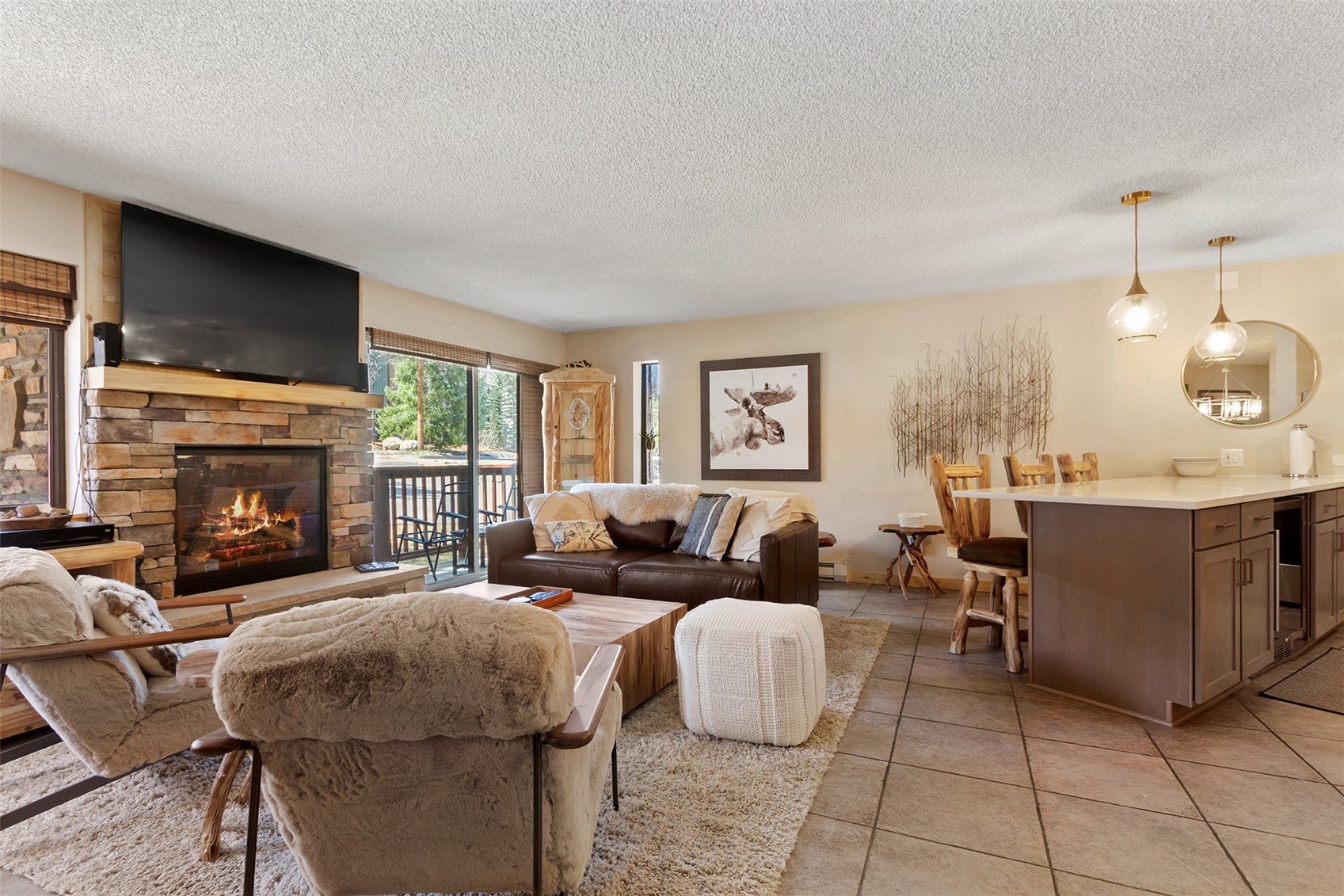 405 4 O Clock Road, Unit 15A Breckenridge, CO 80424 - Photo 2 of 50 a living room with furniture and a fireplace