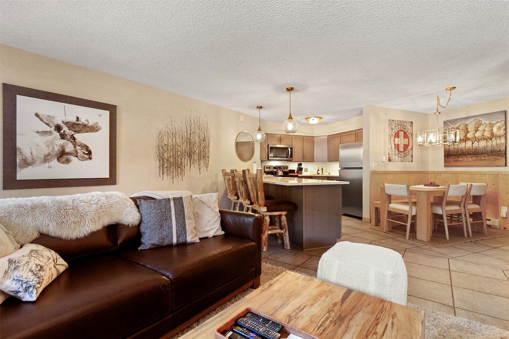 405 4 O Clock Road, Unit 15A Breckenridge, CO 80424 - Photo 21 of 50 a living room with furniture and a dining table with kitchen view