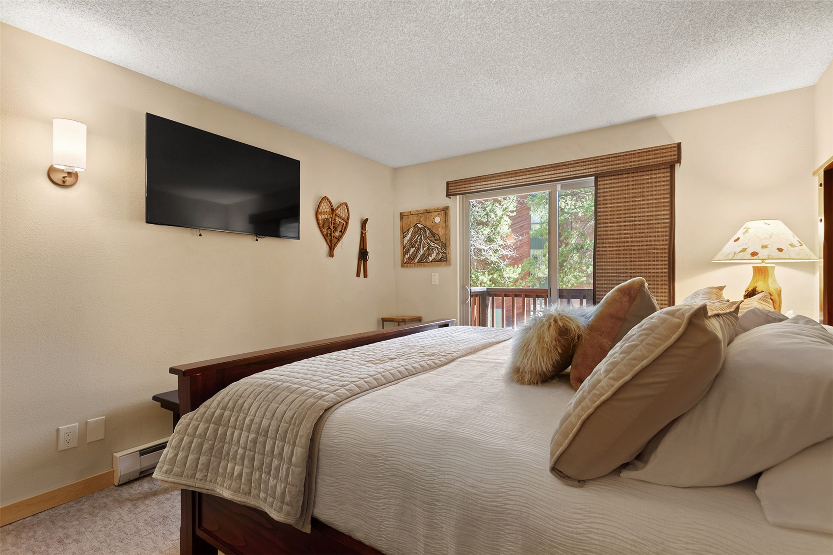 405 4 O Clock Road, Unit 15A Breckenridge, CO 80424 - Photo 24 of 50 a bedroom with a bed and a flat screen tv