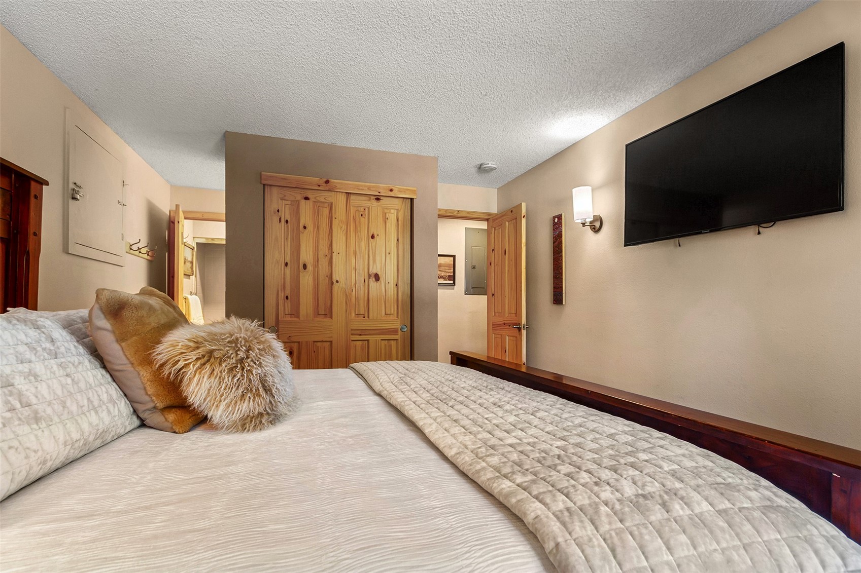 405 4 O Clock Road, Unit 15A Breckenridge, CO 80424 - Photo 25 of 50 a bedroom with a bed and a flat screen tv