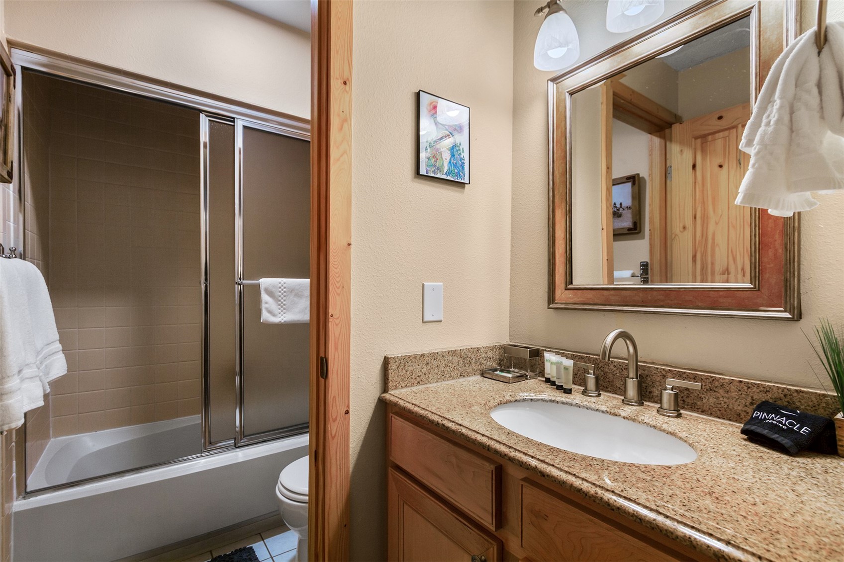 405 4 O Clock Road, Unit 15A Breckenridge, CO 80424 - Photo 26 of 50 a bathroom with a granite countertop sink and a mirror
