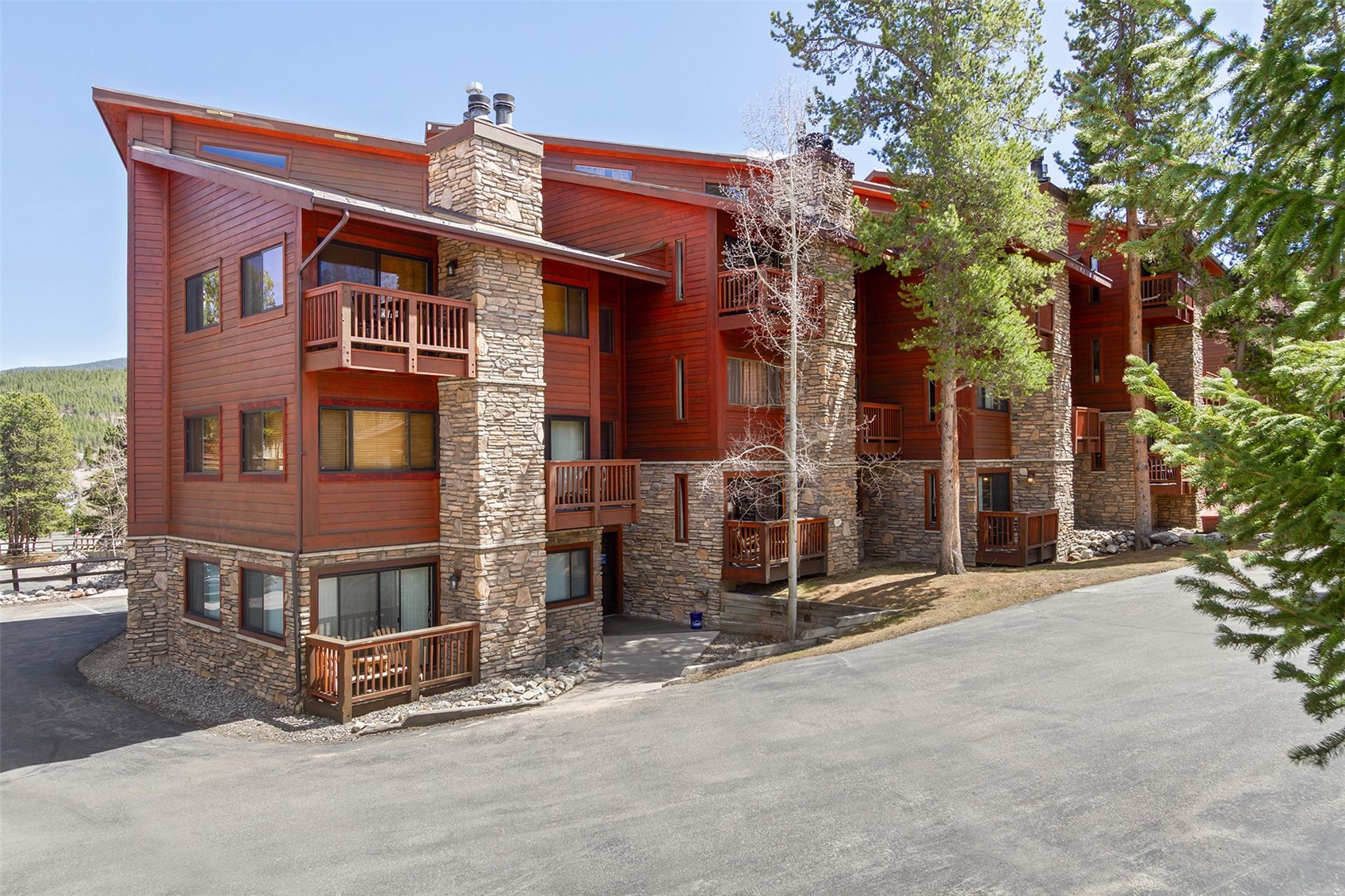 405 4 O Clock Road, Unit 15A Breckenridge, CO 80424 - Photo 35 of 50 a view of a house with a small yard and large tree