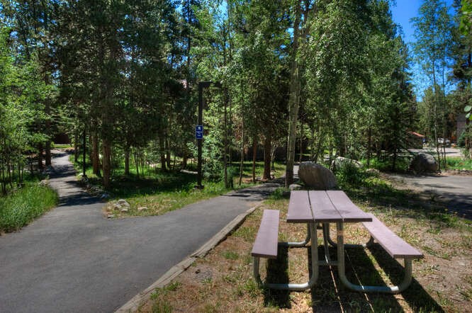 405 4 O Clock Road, Unit 15A Breckenridge, CO 80424 - Photo 47 of 50 a wooden bench sitting in the middle of a park
