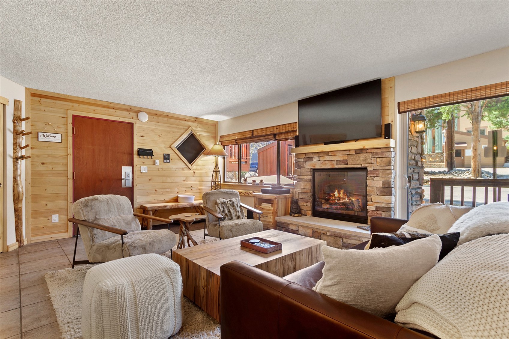405 4 O Clock Road, Unit 15A Breckenridge, CO 80424 - Photo 7 of 50 a living room with furniture fireplace and a large window