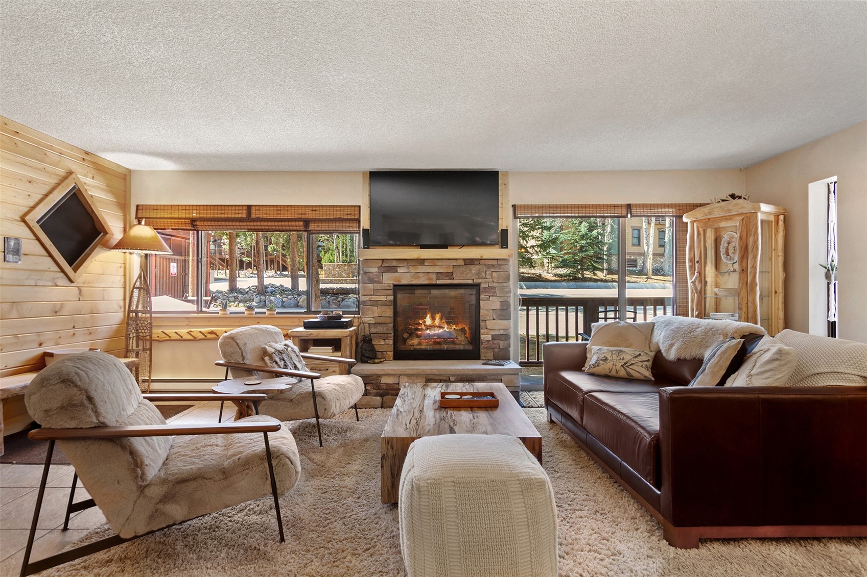 405 4 O Clock Road, Unit 15A Breckenridge, CO 80424 - Photo 8 of 50 a living room with furniture fireplace and a flat screen tv