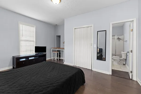 a bedroom with a bed and a dresser
