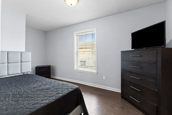 a bedroom with a bed and a flat screen tv