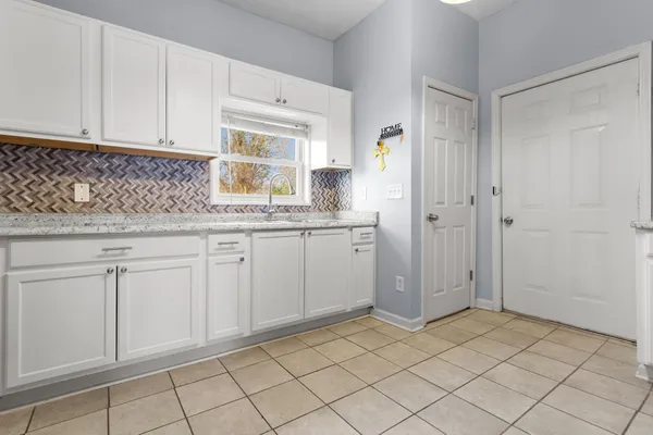 a kitchen with white cabinets