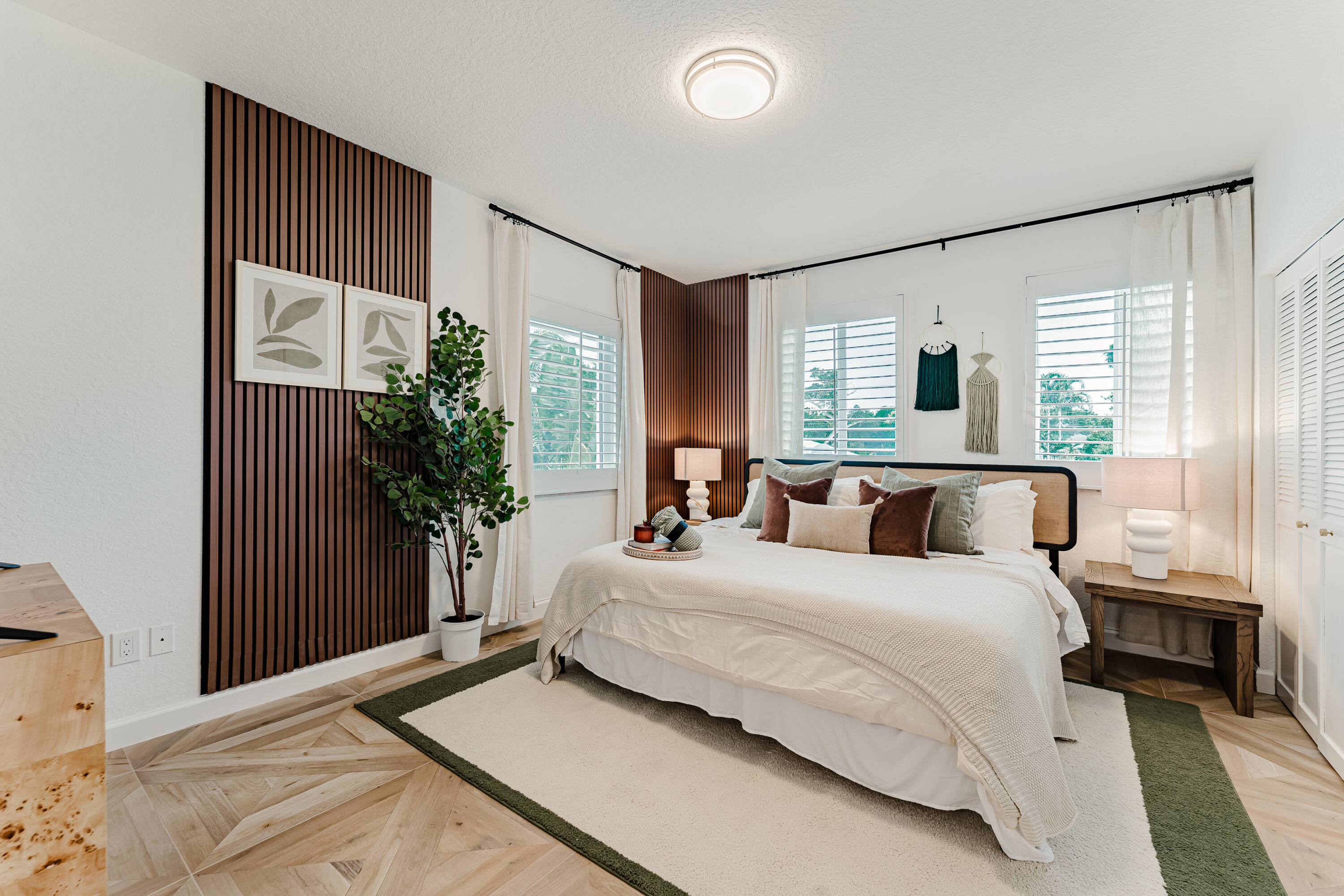 921 Ortega Road West Palm Beach, FL 33405 - Photo 13 of 60 a bedroom with a large bed and a potted plant