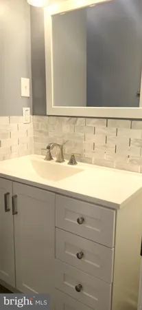a white toilet sitting next to a shower