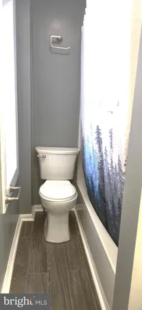 a bathroom with a toilet and a bathtub