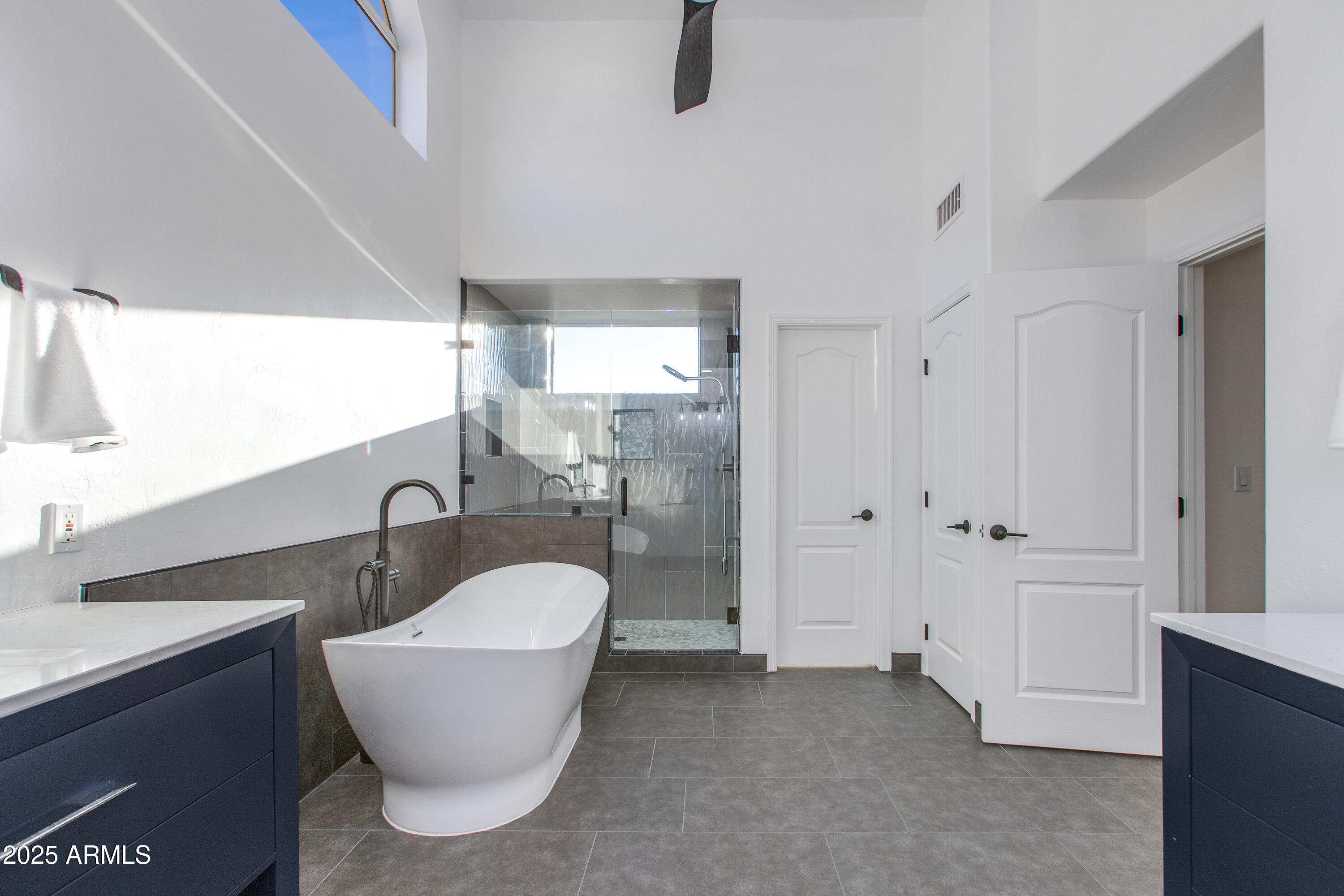 1331 East Voltaire Avenue Phoenix, AZ 85022 - Photo 16 of 33 a bathroom with a white tub shower sink and mirror