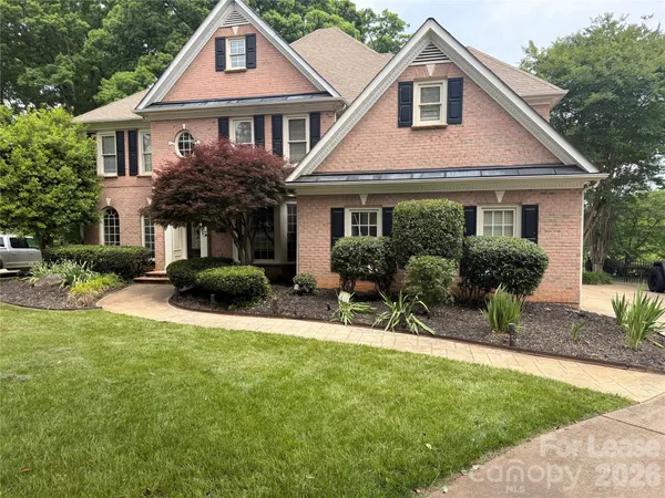 a front view of a house with a yard and porch