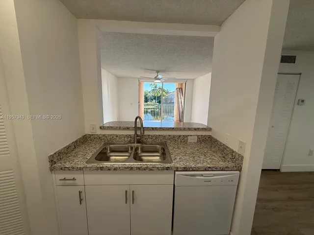 a bathroom with a granite countertop sink and window