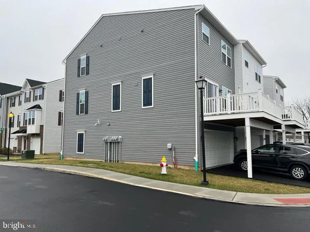 a view of building with car parked on road