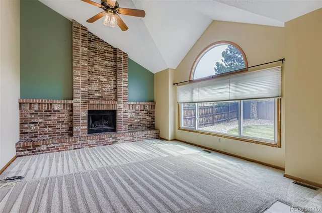 a view of a livingroom with a ceiling fan and window