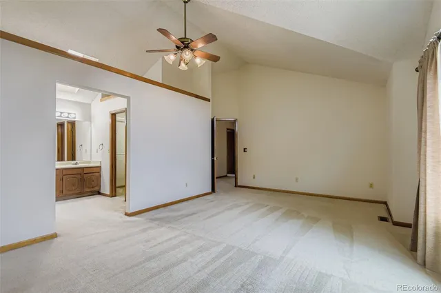 a bathroom with a granite countertop sink a toilet a mirror and shower