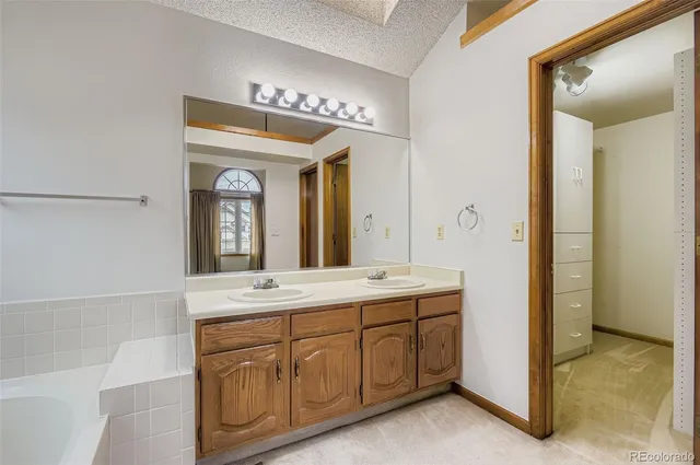 a view of an empty room with a fireplace and cabinets