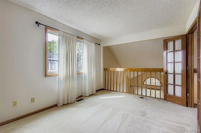 a view of a backyard with wooden floor and fence