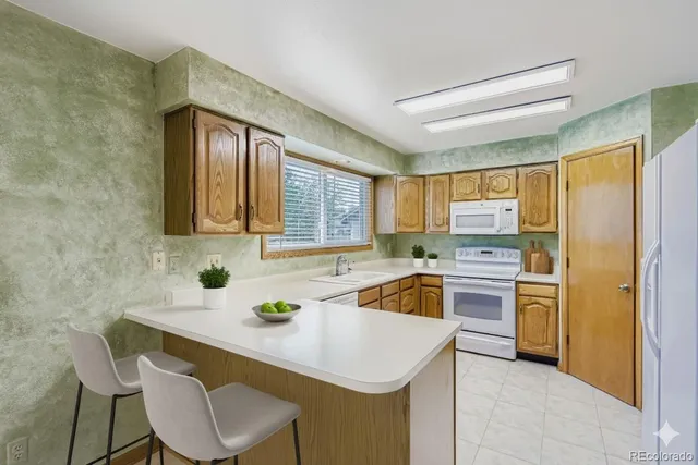 a kitchen with stainless steel appliances a stove a refrigerator and a sink