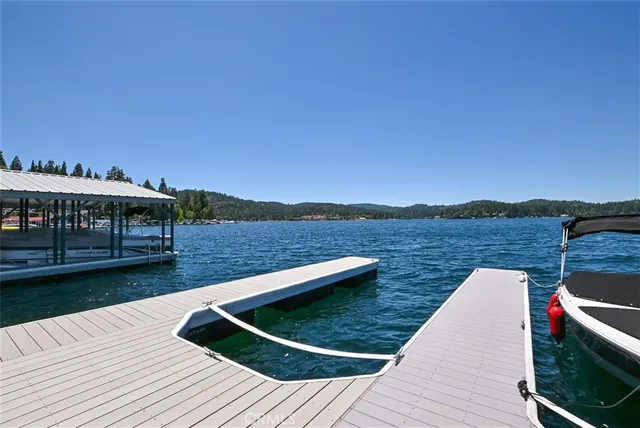 a view of swimming pool with lounge chair and lake view