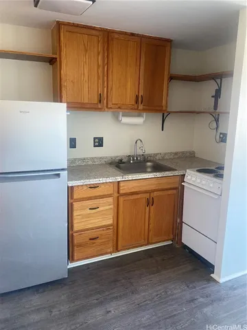 a kitchen with a sink dishwasher stove and cabinets