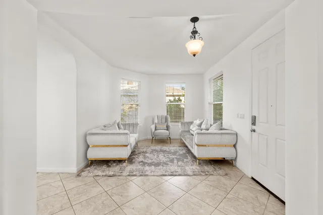 a living room with furniture and a chandelier