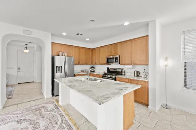 a view of an entryway with wooden floor and a living room