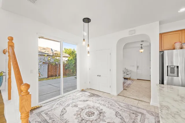 a view of a livingroom with wooden floor and a flat screen tv