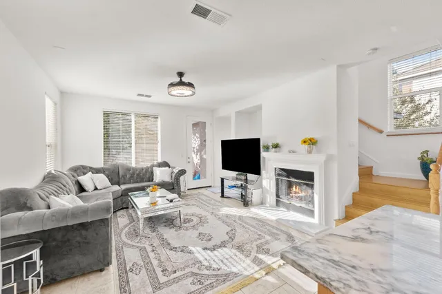 a living room with furniture and a view of kitchen appliances