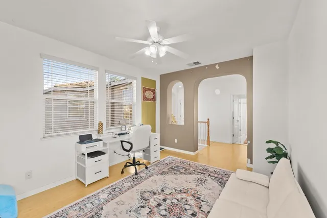 an empty room with a window and wooden floor