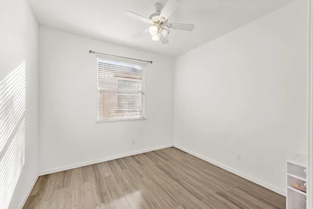 a bedroom with two beds and a window