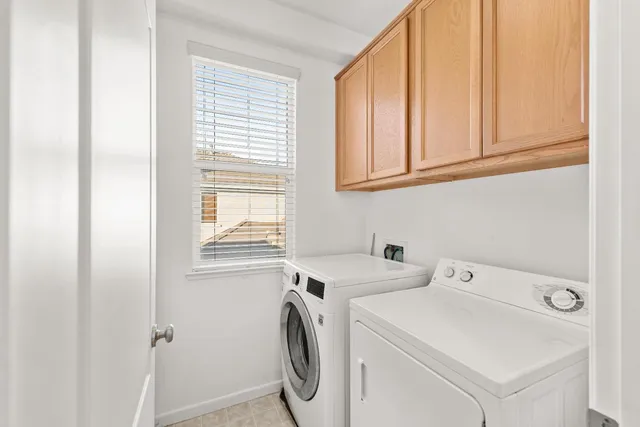 a bedroom with a bed couch and a large window with outer view