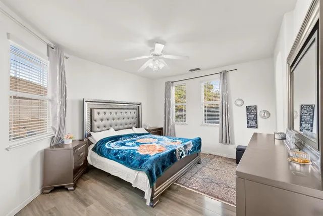 a spacious bathroom with a tub sink and mirror