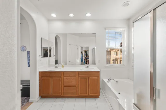 a view of a house with a yard and potted plants